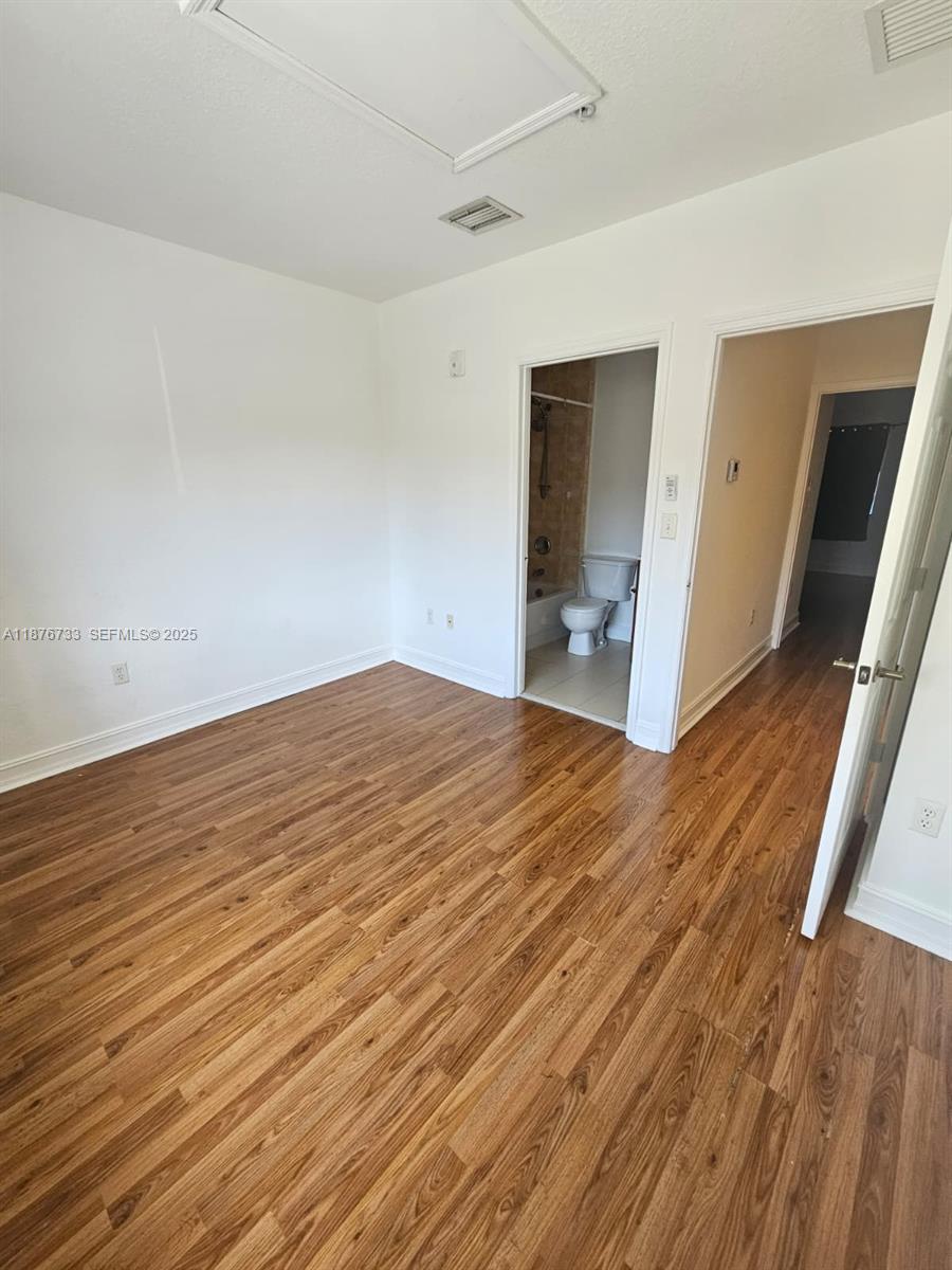 7995 Northwest 8th Street, Unit 103 Miami, FL 33126 - Photo 10 of 17 wooden floor in an empty room