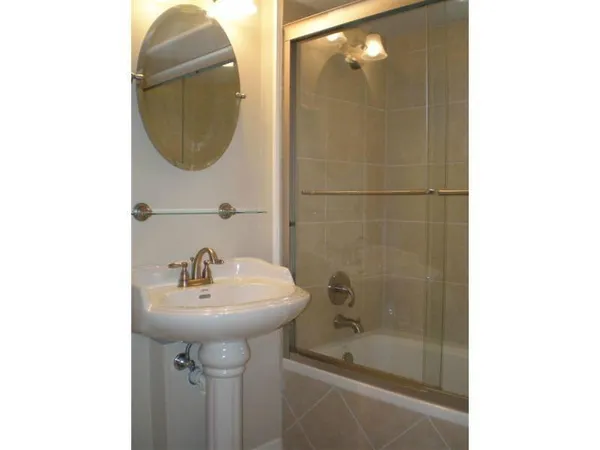 a bathroom with a sink a shower and a mirror