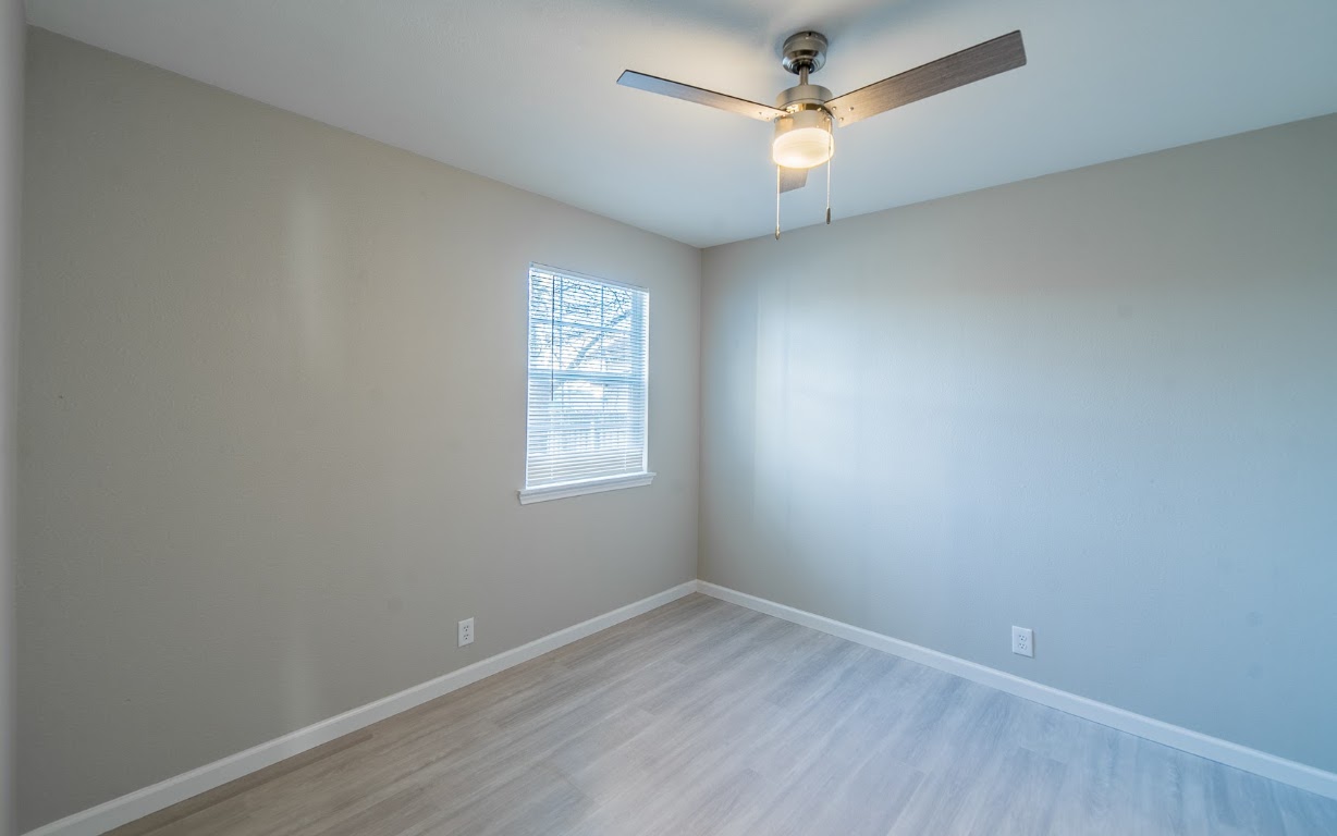 916 Sirocco Drive, Unit B Austin, TX 78745 - Photo 15 of 18 an empty room with a window and a fan