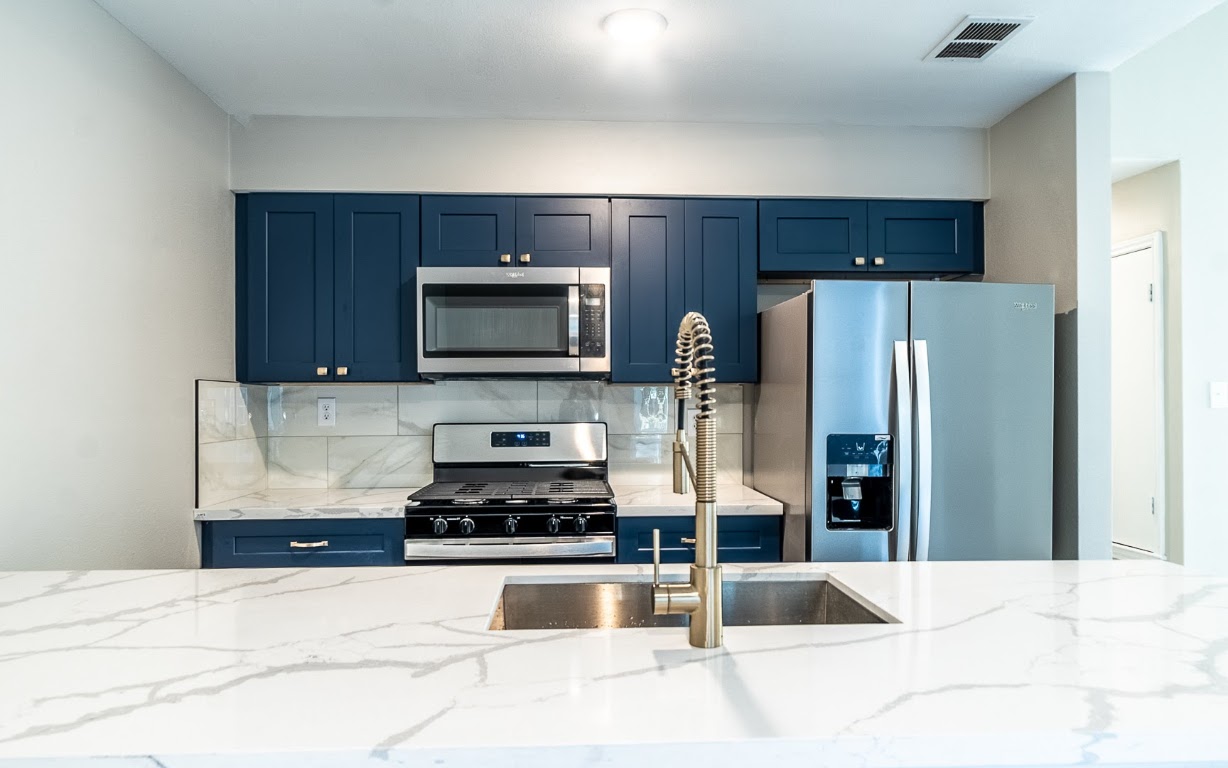 916 Sirocco Drive, Unit B Austin, TX 78745 - Photo 3 of 18 a kitchen with granite countertop a refrigerator and a sink