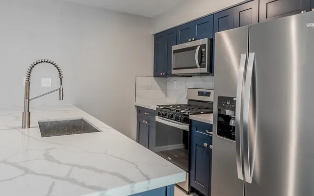 a kitchen with a refrigerator stove and microwave