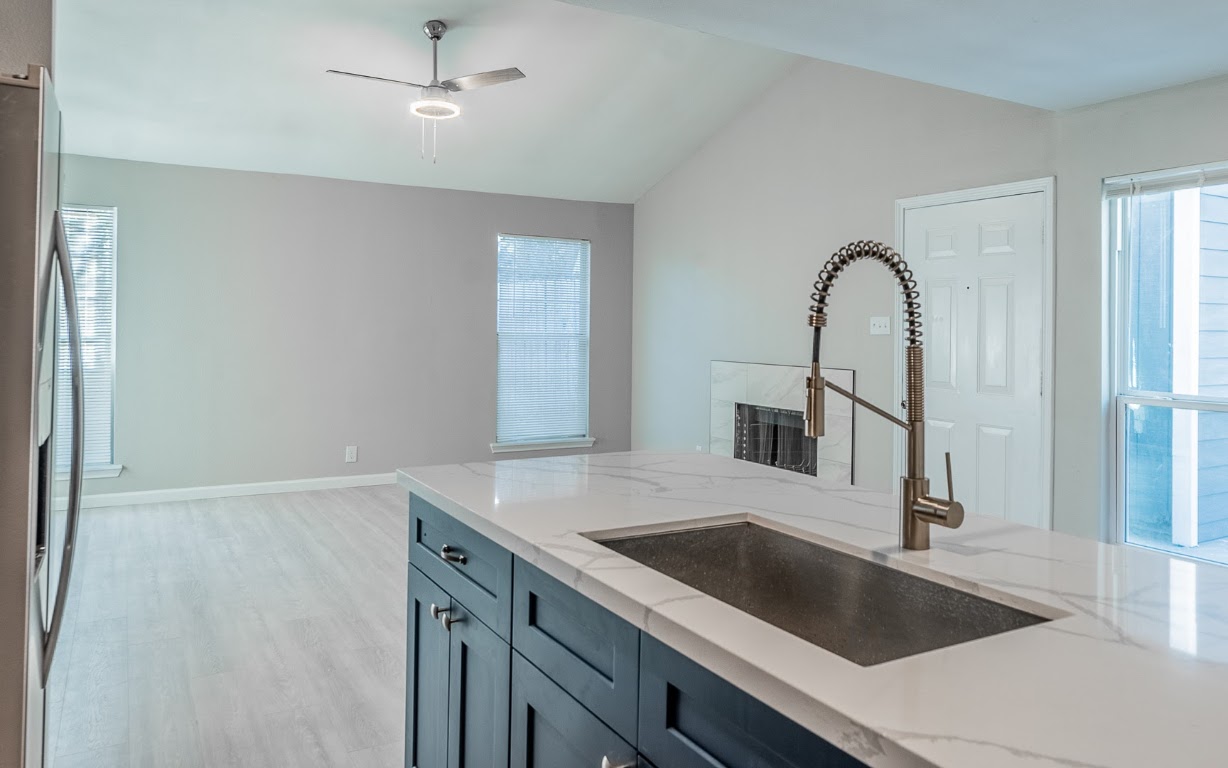 916 Sirocco Drive, Unit B Austin, TX 78745 - Photo 6 of 18 a kitchen with a sink and a refrigerator