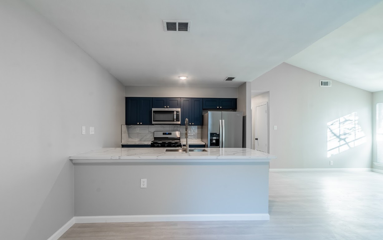 916 Sirocco Drive, Unit B Austin, TX 78745 - Photo 7 of 18 a view of kitchen with stainless steel appliances granite countertop refrigerator sink and stove