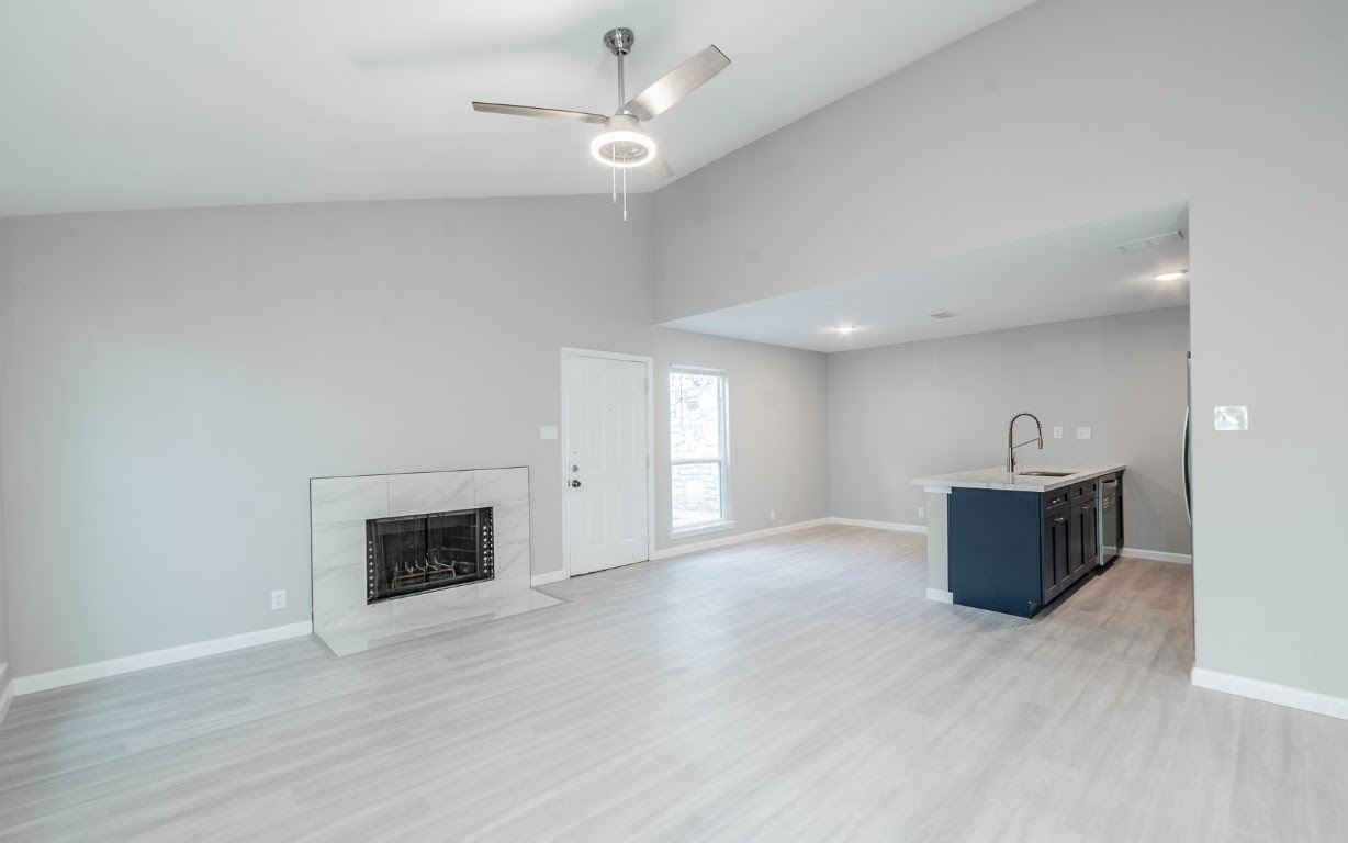 916 Sirocco Drive, Unit B Austin, TX 78745 - Photo 8 of 18 a view of an empty room with a fireplace and a window