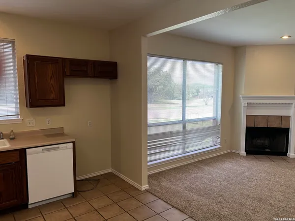 a view of a livingroom with an empty space and a fireplace