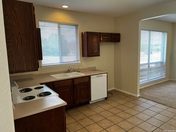 a kitchen with a sink cabinets and window