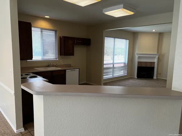 a kitchen with stainless steel appliances granite countertop a sink and a stove
