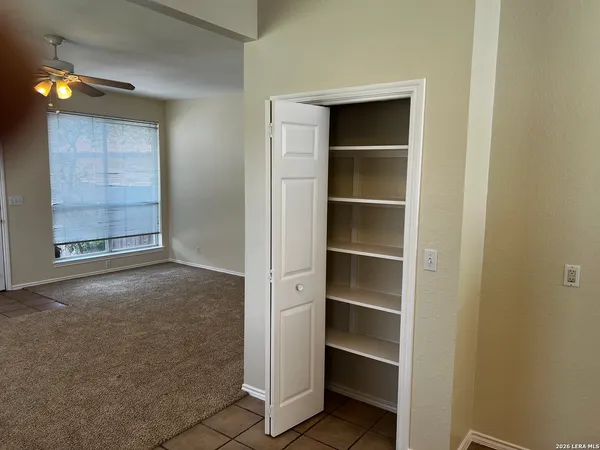 a view of an empty room with a closet
