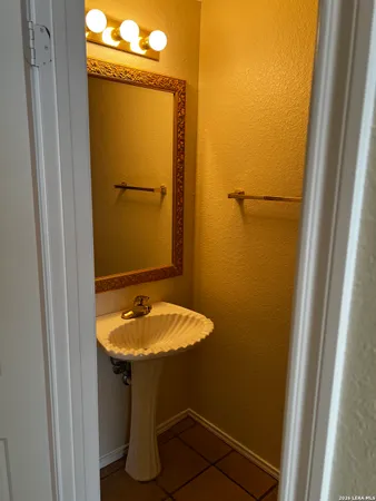a bathroom with a sink and mirror