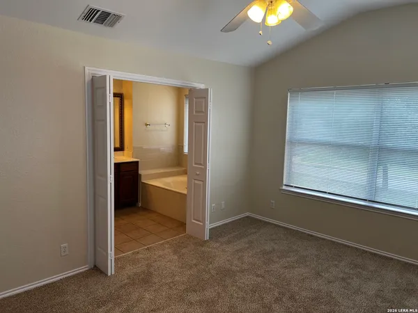 an empty room with a bathroom and a sink