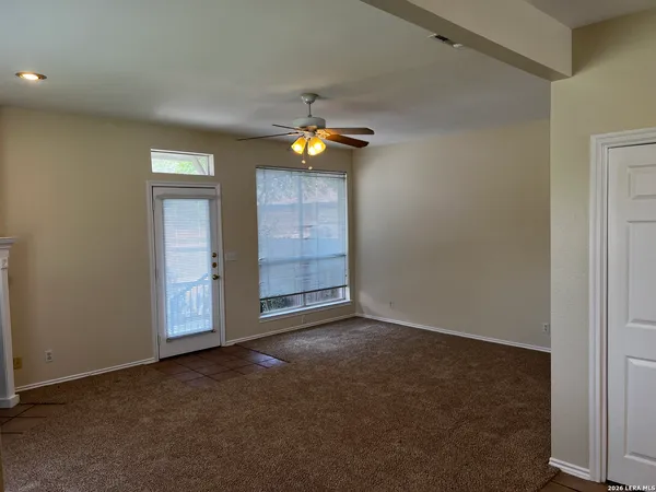 an empty room with closet and windows