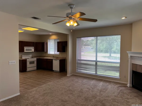 a view of kitchen with refrigerator and window