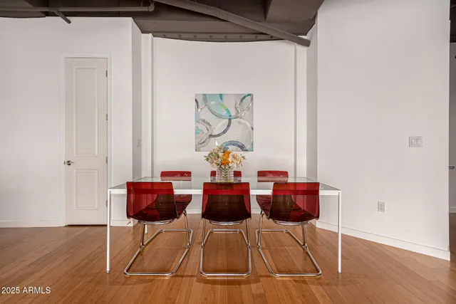a dining room with furniture and wooden floor