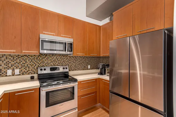 a kitchen with a refrigerator sink and stove