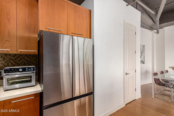 a kitchen with stainless steel appliances a refrigerator and a stove top oven