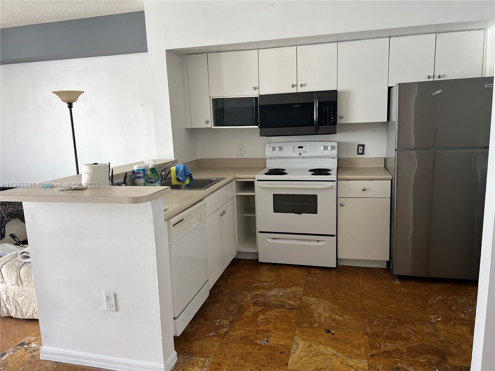 Flagami Miami, FL 33126 - Photo 3 of 19 a kitchen with a sink a stove and refrigerator