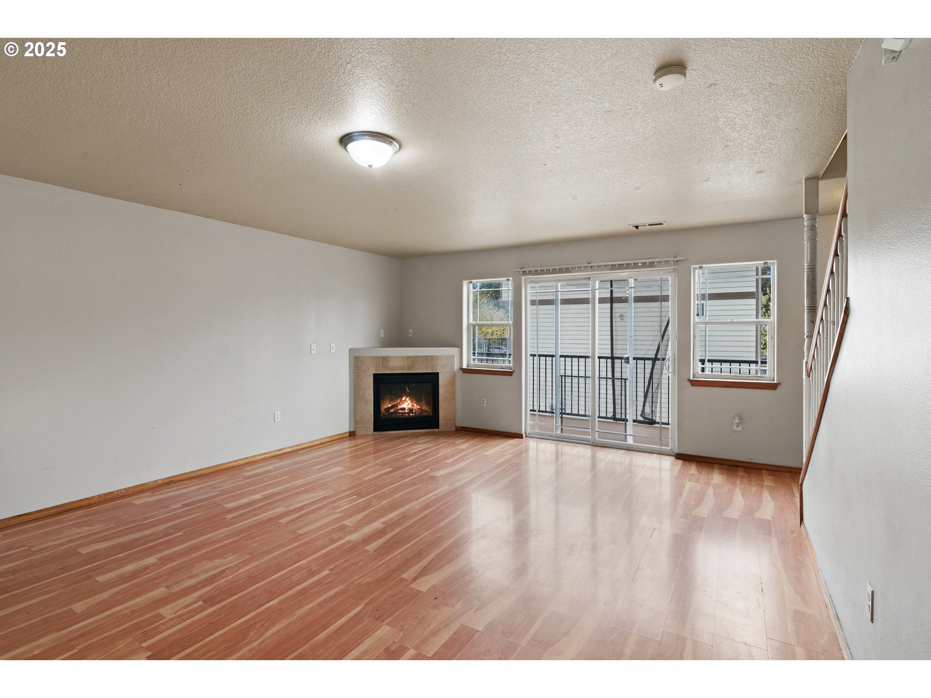 2518 Southeast 130th Avenue, Unit 5 Portland, OR 97236 - Photo 3 of 13 a view of an empty room with a fireplace and a window
