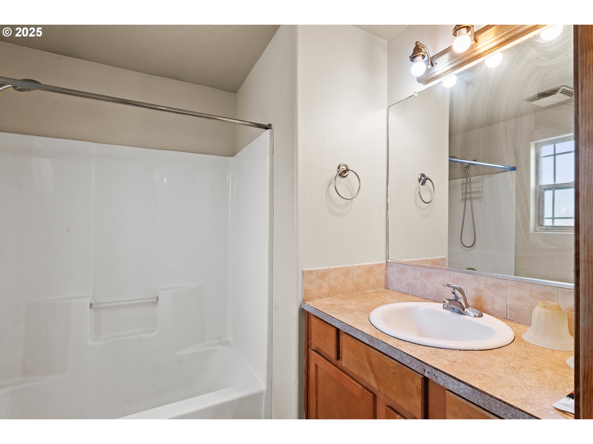 2518 Southeast 130th Avenue, Unit 5 Portland, OR 97236 - Photo 10 of 13 a bathroom with a sink and a mirror