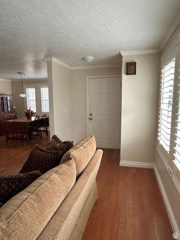 254 Meadow Lane Centerville, UT 84014 - Photo 11 of 34 Entryway featuring a paneled door, crown molding, and wood-finish flooring