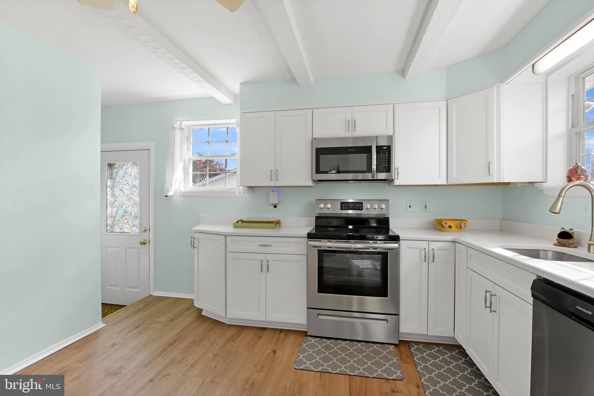 9641 Dundawan Road Baltimore, MD 21236 - Photo 12 of 37 a kitchen with stainless steel appliances granite countertop a stove a sink and a microwave