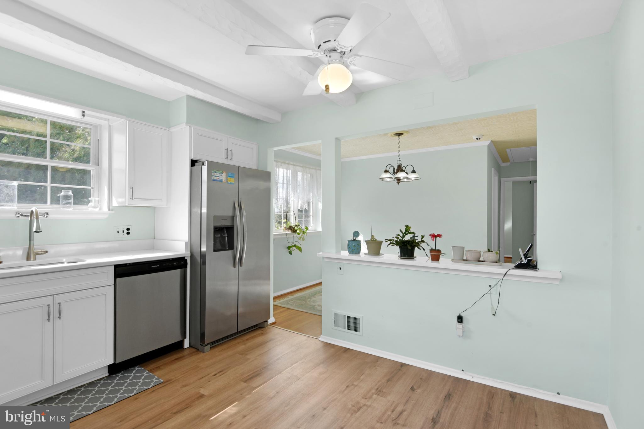 9641 Dundawan Road Baltimore, MD 21236 - Photo 13 of 37 a kitchen with a refrigerator sink and cabinets