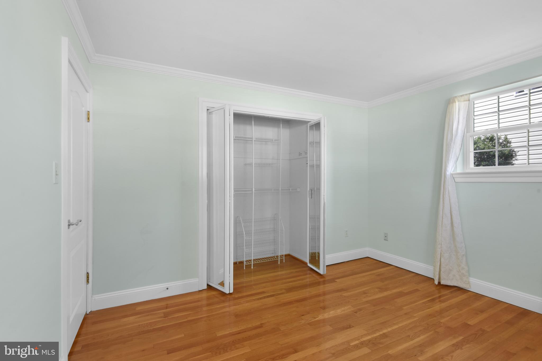 9641 Dundawan Road Baltimore, MD 21236 - Photo 16 of 37 a view of empty room with wooden floor and fan