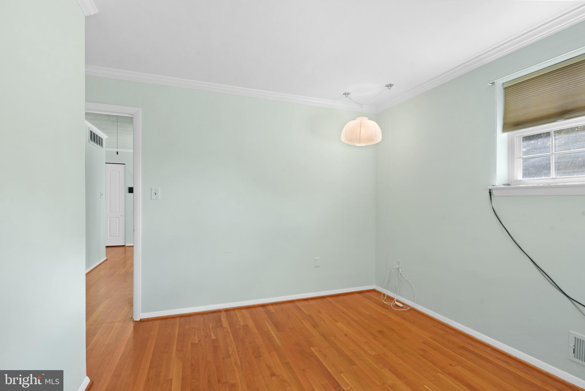 9641 Dundawan Road Baltimore, MD 21236 - Photo 19 of 37 a view of an empty room with wooden floor and a window