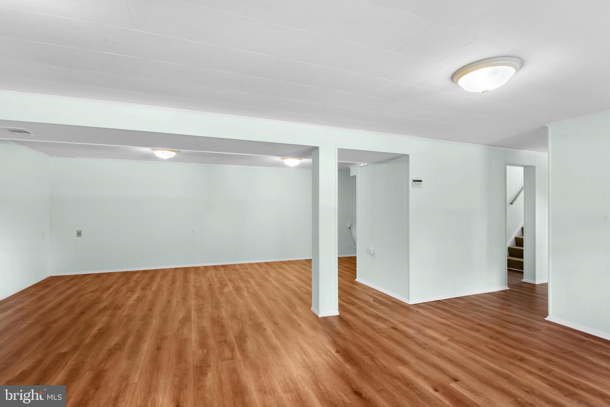 9641 Dundawan Road Baltimore, MD 21236 - Photo 20 of 37 a view of an empty room with wooden floor