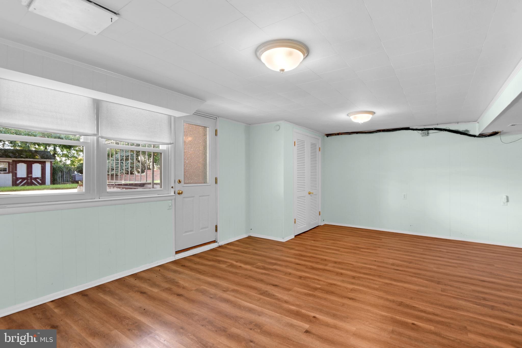 9641 Dundawan Road Baltimore, MD 21236 - Photo 6 of 37 a view of empty room with wooden floor and fan
