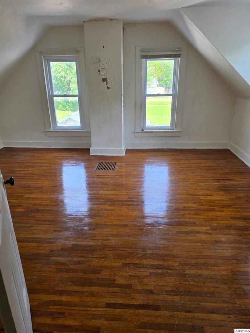 304 West 3rd Street Golden, IL 62339 - Photo 11 of 18 a view of a room with window and wooden floor