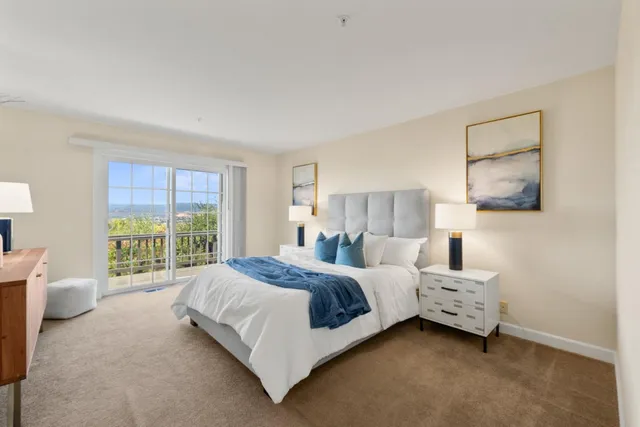 a bedroom with a bed a couch and a window