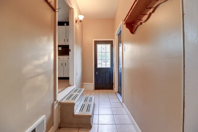 a bedroom with a bed and a night stand