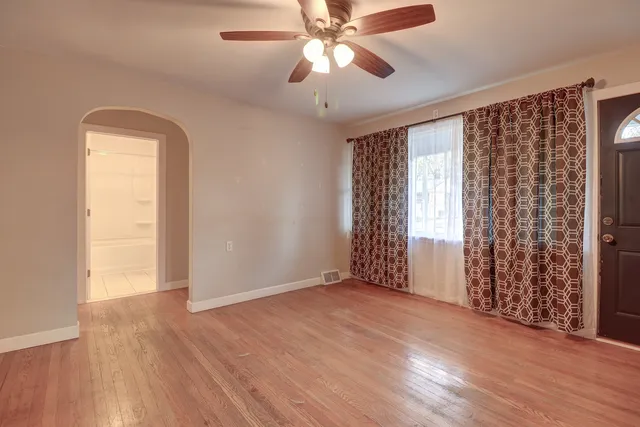 wooden floor in an empty room with a window