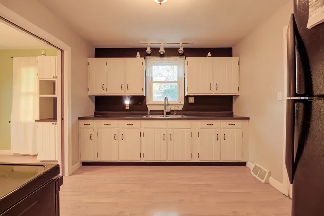 a kitchen with stainless steel appliances a refrigerator sink and cabinets