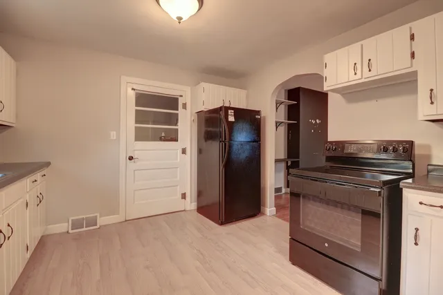 a kitchen with granite countertop cabinets and steel stainless steel appliances