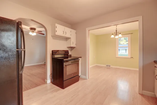 a kitchen with a refrigerator and a stove top oven