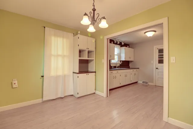 a view of a kitchen with a sink and cabinet area