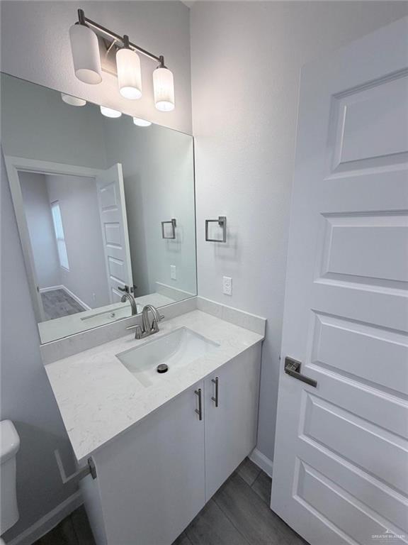 1704 Clinton Street, Unit 2 Harlingen, TX 78550 - Photo 12 of 13 a bathroom with a sink and a mirror