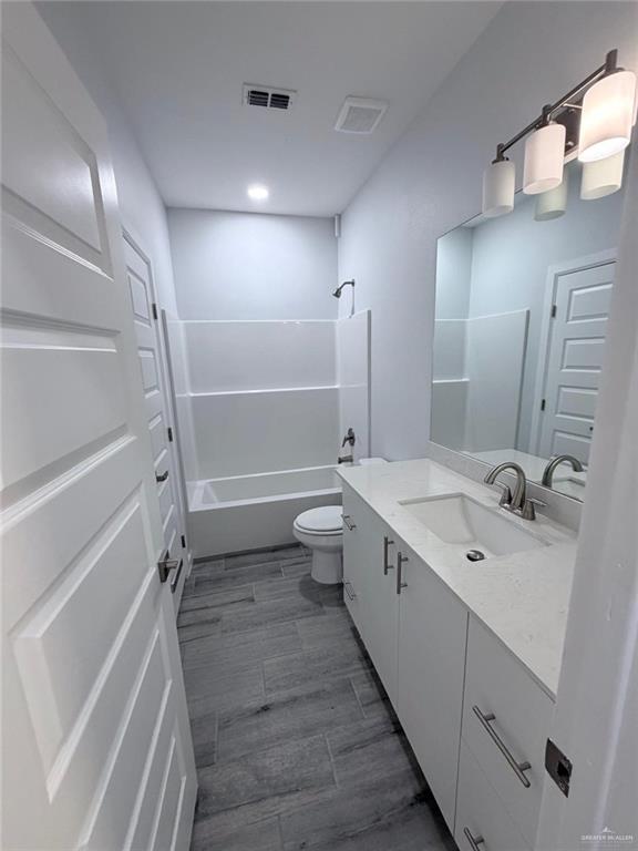 1704 Clinton Street, Unit 2 Harlingen, TX 78550 - Photo 9 of 13 a bathroom with a double vanity sink toilet mirror and shower