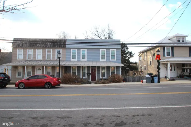 a front view of residential houses with street
