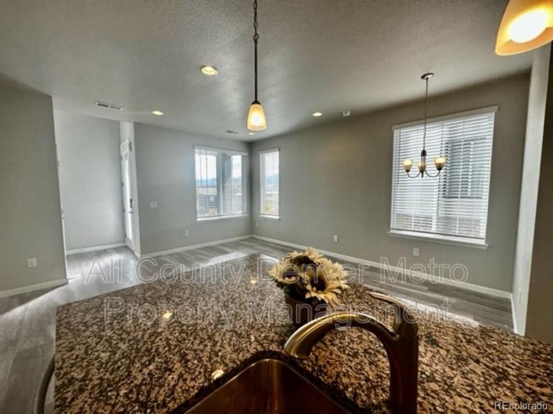 19580 West 92nd Drive, Unit E Arvada, CO 80007 - Photo 13 of 25 a view of a livingroom with furniture and window
