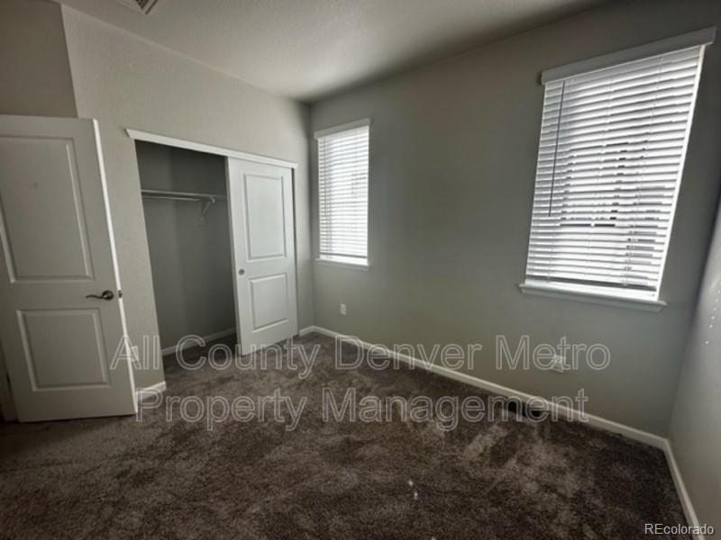 19580 West 92nd Drive, Unit E Arvada, CO 80007 - Photo 17 of 25 an empty room with windows