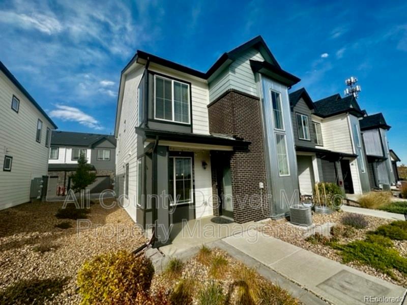19580 West 92nd Drive, Unit E Arvada, CO 80007 - Photo 2 of 25 a front view of a house with a yard