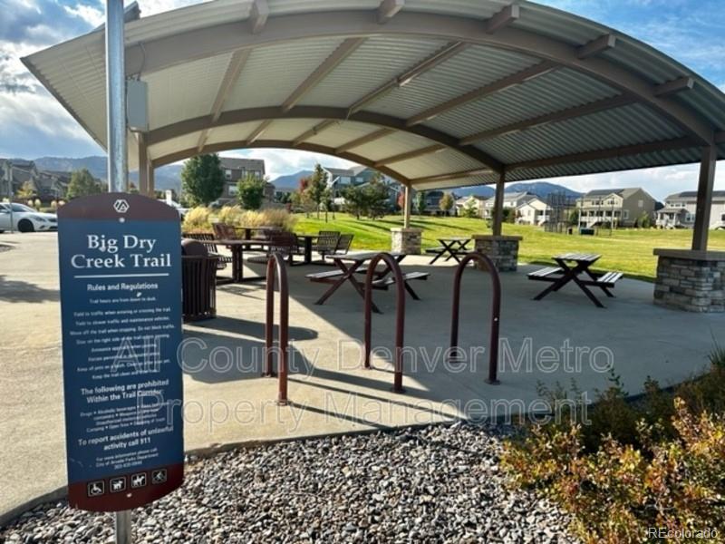 19580 West 92nd Drive, Unit E Arvada, CO 80007 - Photo 23 of 25 a view of a patio with table and chairs under an umbrella