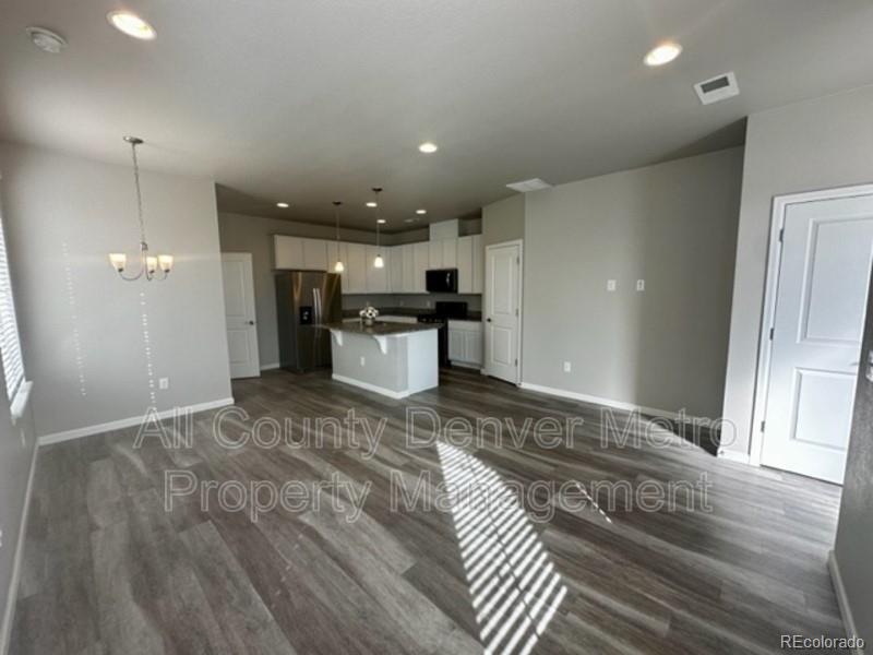 19580 West 92nd Drive, Unit E Arvada, CO 80007 - Photo 3 of 25 a view of a kitchen with a sink and a refrigerator