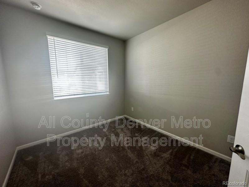 19580 West 92nd Drive, Unit E Arvada, CO 80007 - Photo 9 of 25 a view of an empty room with a window
