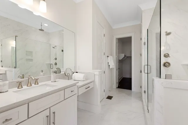 a bathroom with a double vanity sink mirror and shower