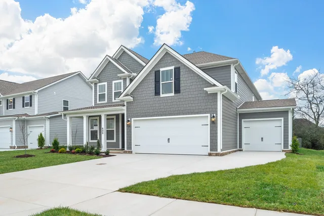 a view of a hallway with wooden floor and a bathroom