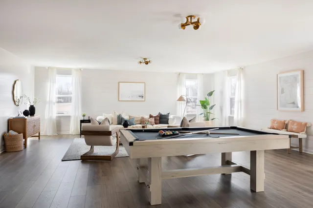 a living room with furniture and a mirror
