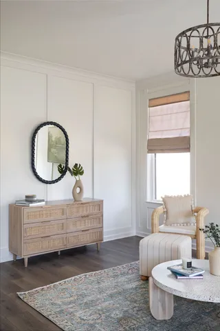 a living room with furniture a fireplace and a chandelier